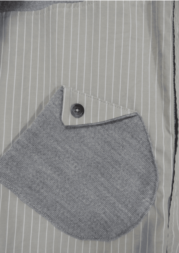 Détail poche d'un pull créé à partir d'un mix de pull et de chemise de seconde main